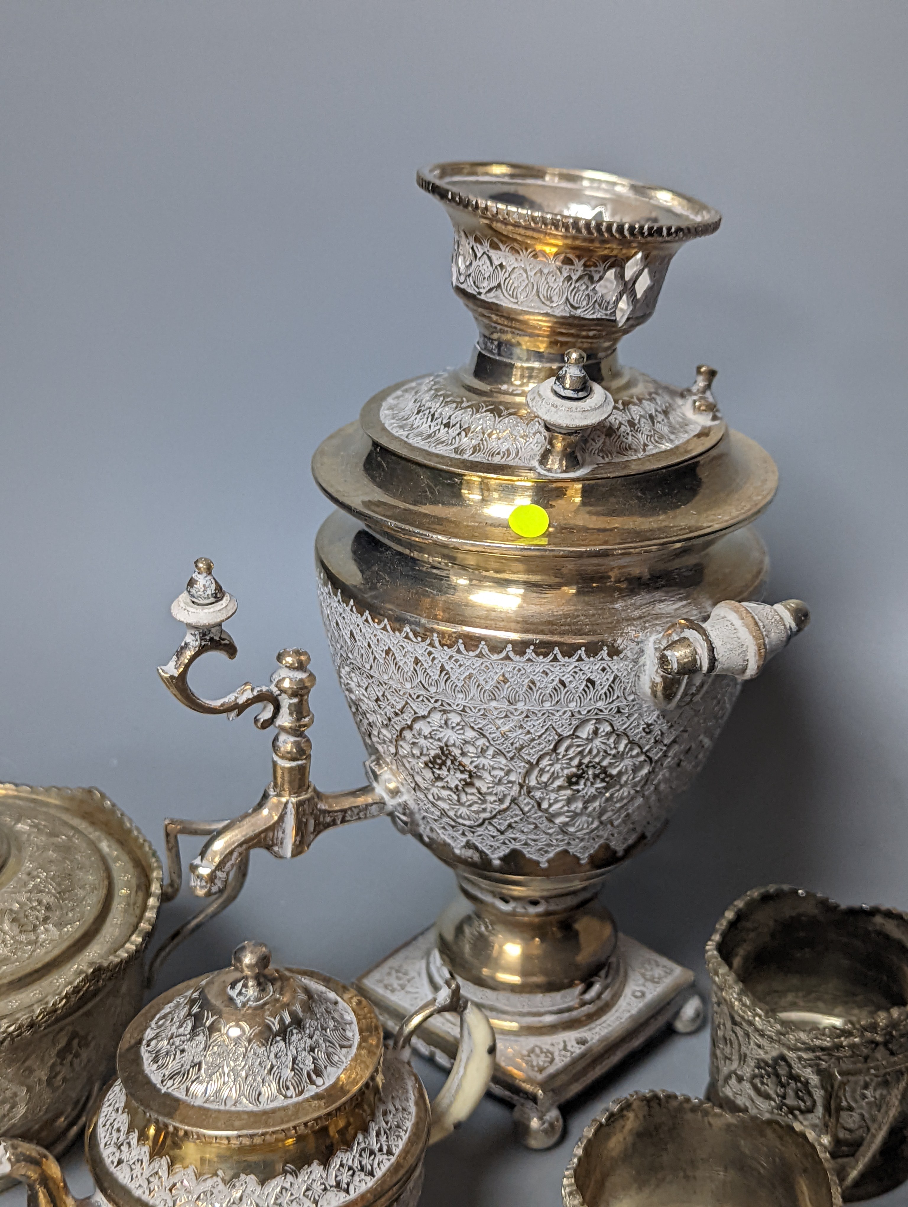 A set of six Persian embossed 84 standard white metal coffee cup holders and matching sugar bowl and cover by Vartan and four other Persian white metal items.